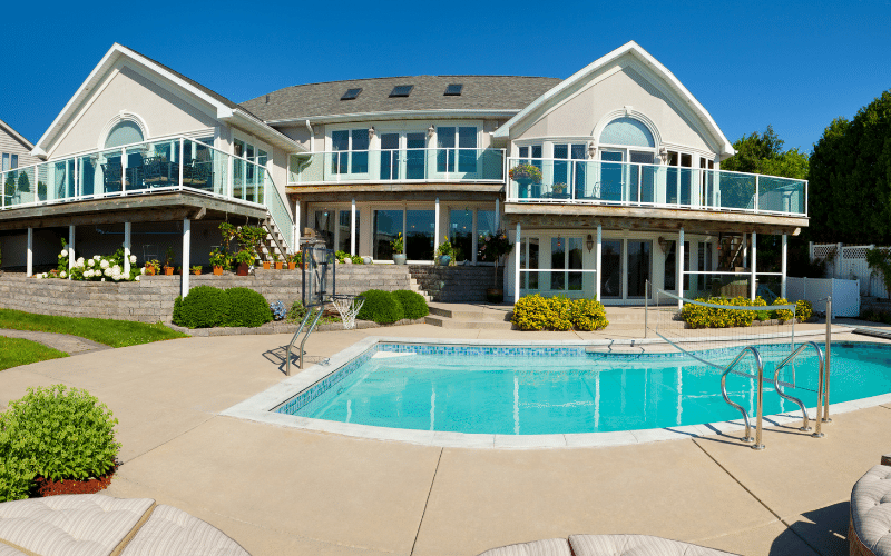 large home with pool and concrete pad